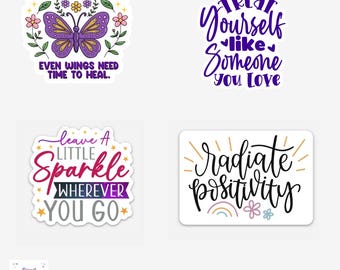 Puede incluir: Cuatro pegatinas con citas inspiradoras. Una presenta una mariposa morada y el texto "It's okay to pause. Even wings need time to heal." Otra dice "Treat yourself like someone you love."