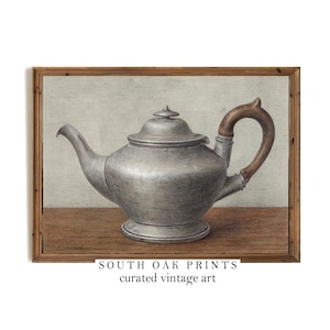 May include: A vintage illustration of a silver teapot with a wooden handle. The teapot is sitting on a wooden table. The illustration is framed in a wooden frame. The text "SOUTH OAK PRINTS curated vintage art" is at the bottom of the image.