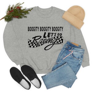 May include: A grey sweatshirt with the text "Boogitty Boogitty Boogitty Let's Go Racing" in black. The text is accompanied by a black and white chequered flag.