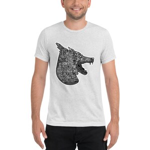 May include: A heather grey t-shirt featuring a black and white graphic of a wolf's head. The wolf's head is made up of the words "Born to be wild" and "Brothers".