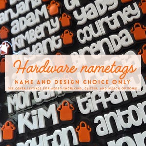May include: A collection of custom name tags featuring white raised lettering on a black background, each accompanied by a small orange apron icon. The image includes overlaid text stating Hardware nametags, NAME AND DESIGN CHOICE ONLY.