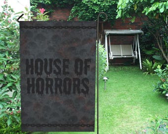 May include: A black and gray garden flag with a rusty metal texture and the text "HOUSE OF HORRORS" in black dripping letters.