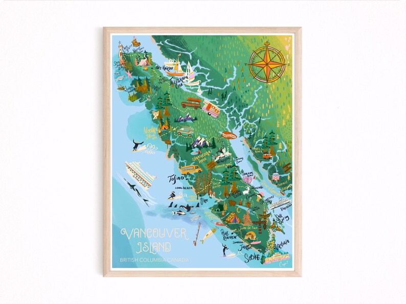 May include: A framed map print of Vancouver Island, British Columbia, Canada. The map is illustrated with a green and blue color scheme, featuring landmarks, boats, and a compass rose. The words "Vancouver Island" are written in a decorative font.
