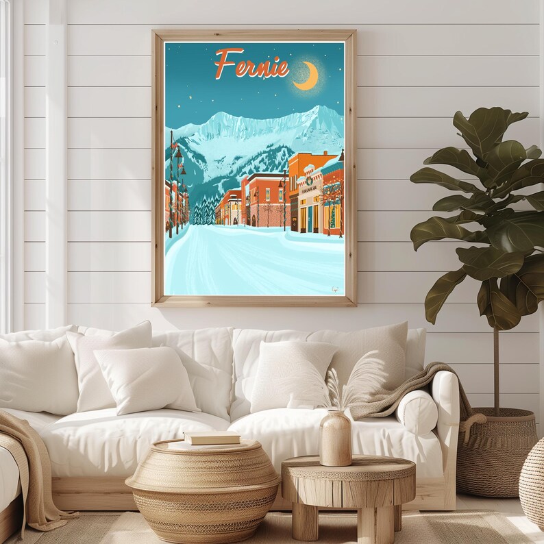 May include: A retro-style travel poster featuring a snowy mountain town scene with the text "Fernie" at the top. The town is depicted with colorful buildings and a crescent moon in the sky.