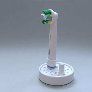 Oral-B toothbrush stand with drip tray, head holder attachment, round design version for the bathroom. Hygienic accessories image 3