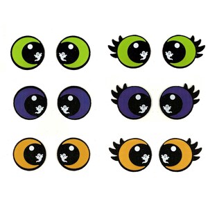 May include: A collection of Halloween-themed eye designs. Each eye features a crescent moon shape in green, purple, or orange, with a black pupil and a small white ghost. Some eyes have black eyelashes.