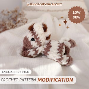 May include: A plush crochet zebra toy with brown and white striped yarn, featuring a small mane, a tail, and black bead eyes. The image includes text reading @JENNYLOOPYDO CROCHET, LOW SEW, ENGLISH|PDF FILE, and CROCHET PATTERN MODIFICATION.