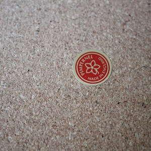 May include: A red and gold circular sticker with the text "Pimpernel, Made in England" and a flower design.