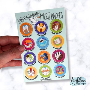 May include: A light blue card with a white stork and the text "Labor & Delivery Merit Badges". The card features 12 colorful circles with illustrations of different labor and delivery scenarios, such as a first delivery, cord prolapse, water birth, and twin deliveries. The card also includes the text "@AmyPattersonArt".