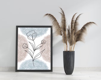 Puede incluir: Una impresión enmarcada en negro con un dibujo minimalista de una flor con tres flores sobre un fondo de círculos de acuarela azul y marrón.