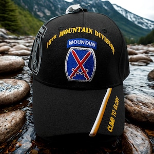 May include: Black baseball cap featuring the text "10th Mountain Division" in gold lettering. The cap has a patch with a blue background and crossed red swords. The brim has the text "CLIMB TO GLORY" in gold.