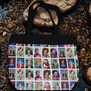 May include: Black tote bag featuring a repeating pattern of Frida Kahlo portraits. The colorful images are set against a white background. The bag has black handles and a black top.