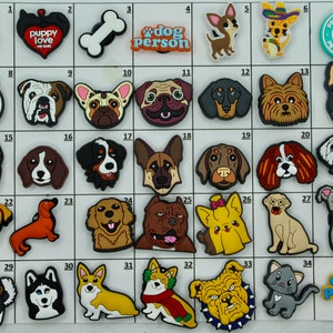 May include: A set of 35 colorful shoe charms featuring various dog breeds, including a bulldog, dachshund, corgi, and a pug. There are also charms with phrases like "puppy love" and "dog person".