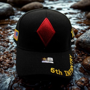 May include: Black baseball cap featuring a red diamond emblem and the words "5th INFANTRY" in yellow. The cap also displays a small American flag patch and a US Army emblem.