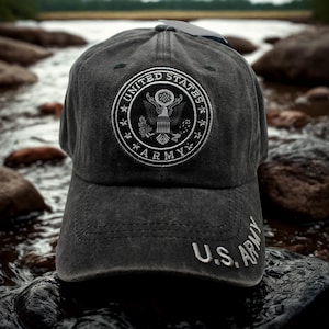 May include: A charcoal gray baseball cap featuring a circular embroidered patch with the words "UNITED STATES ARMY" and an eagle emblem. The text "U.S. ARMY" is embroidered on the brim. The cap is made of a worn, textured fabric.