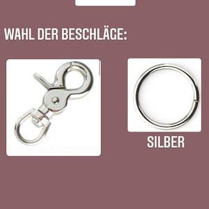 K&ouml;nnte beinhalten: Zwei silberne Metallverschl&uuml;sse f&uuml;r eine Hundeleine. Der Verschluss links ist ein Federverschluss. Der Verschluss rechts ist ein einfacher Ring. Der Text "SILBER" befindet sich unter dem Ringverschluss.