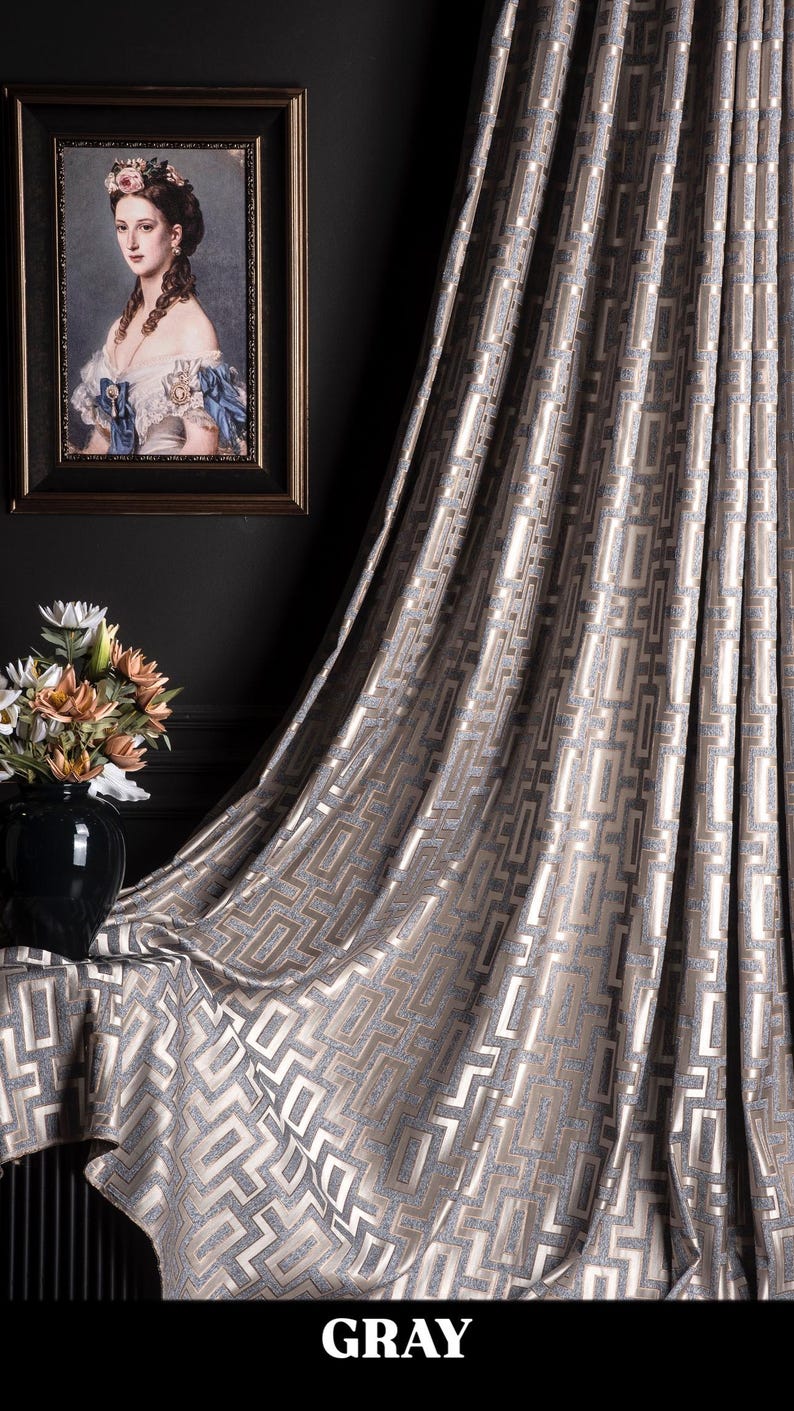 May include: Gray patterned curtain with a geometric design. The curtain is made of a soft, luxurious fabric and has a subtle sheen.