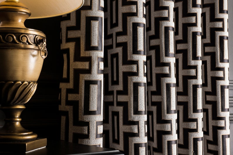 May include: Black and white geometric patterned curtains with gold accents. The curtains are made of a textured fabric and have a modern design.