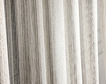 May include: Close-up of a white sheer curtain with a textured weave. The curtain is made of a lightweight fabric and has a subtle sheen.