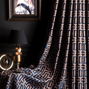 May include: Navy blue curtains with a geometric pattern of squares and rectangles. The curtains are made of a soft, luxurious fabric and have a subtle sheen.