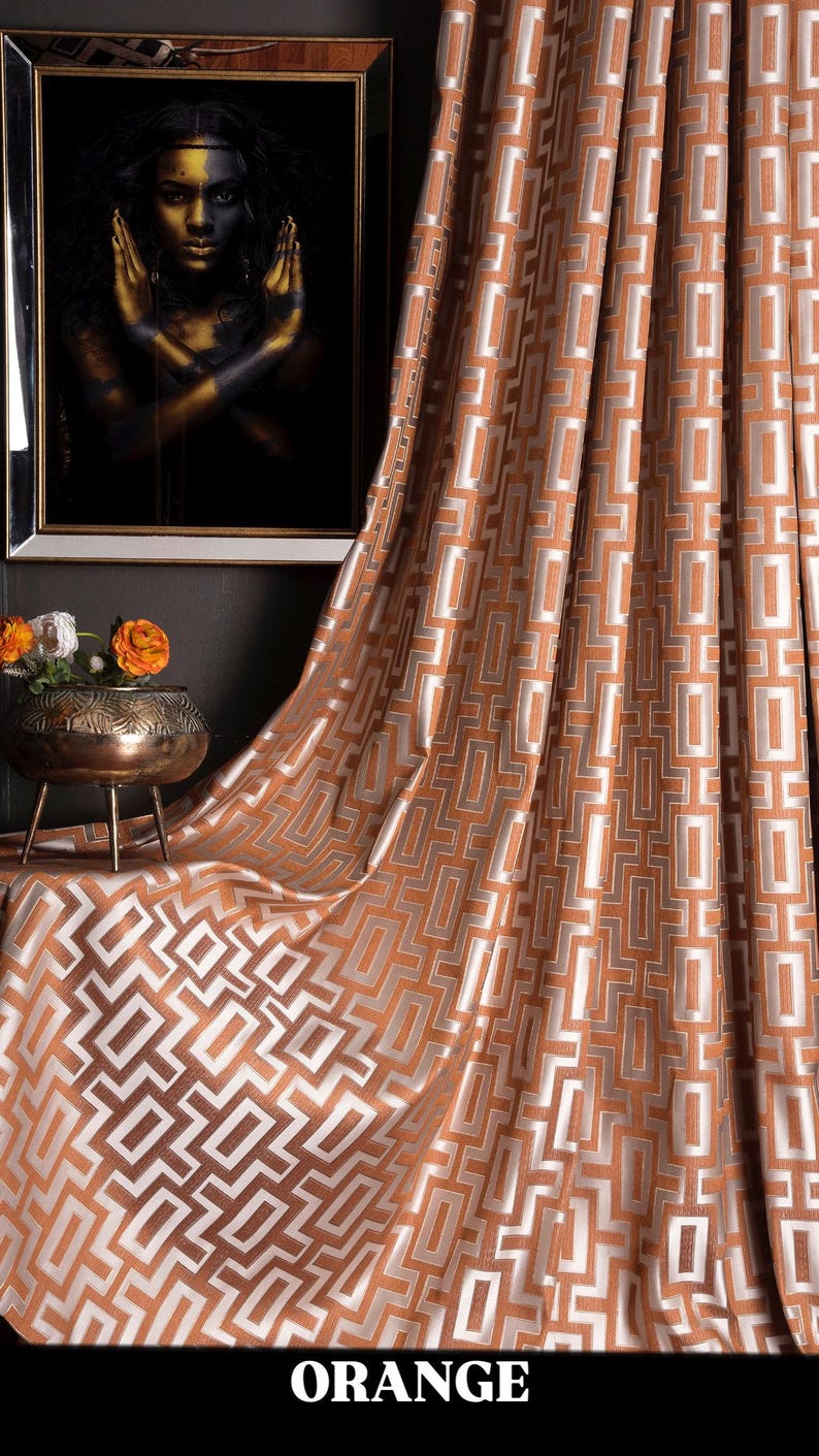 May include: Orange curtains with a geometric pattern of white squares on a brown background. The curtains are made of a soft, luxurious fabric and have a subtle sheen.