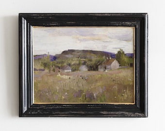 May include: A framed oil painting depicting a rural landscape with a small village nestled among rolling hills. The painting features a muted color palette of greens, browns, and blues, with a soft, hazy sky.
