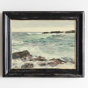 The image is a framed painting depicting a rocky coastline with crashing waves.