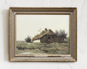May include: A framed painting depicting a rustic cottage with a thatched roof, surrounded by trees and a grassy field. The painting is set against a light blue sky with white clouds.