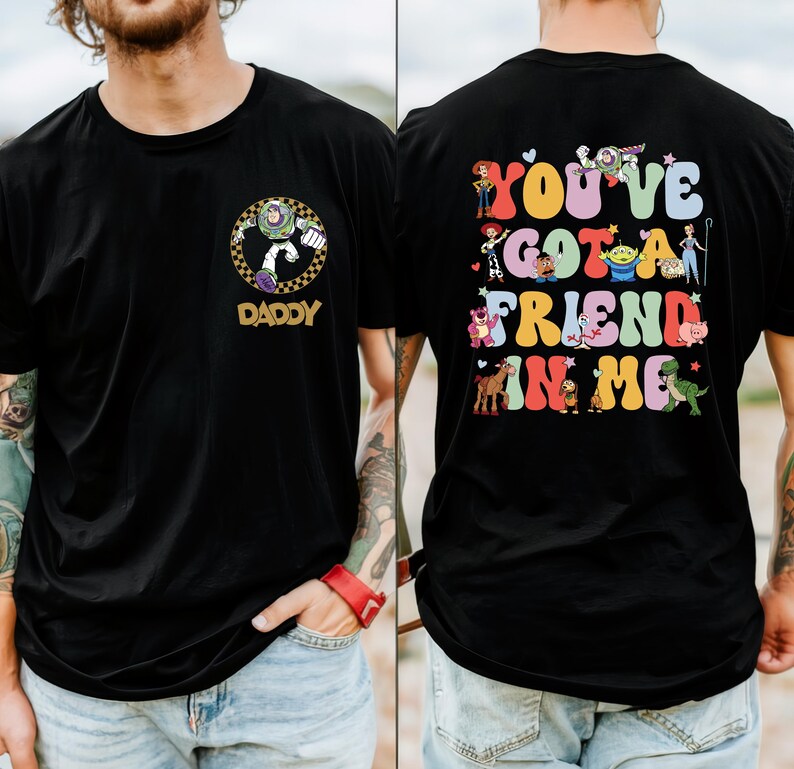 May include: Black t-shirt with a Buzz Lightyear graphic and the word "DADDY" on the front. The back of the shirt has the phrase "YOU'VE GOT A FRIEND IN ME" with colourful Toy Story characters.