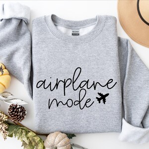 May include: Gray sweatshirt with the text "airplane mode" in black cursive lettering and a small airplane graphic.
