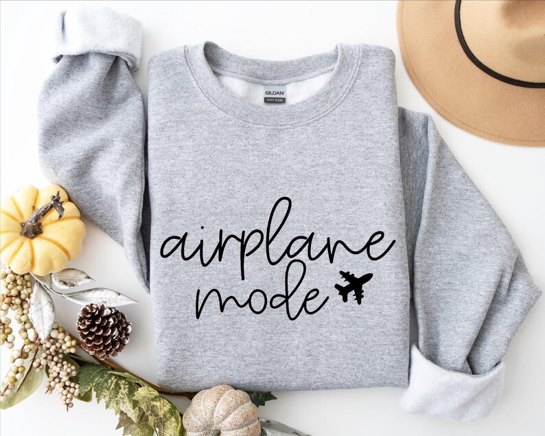 May include: Gray sweatshirt with the text "airplane mode" in black cursive lettering and a small airplane graphic.