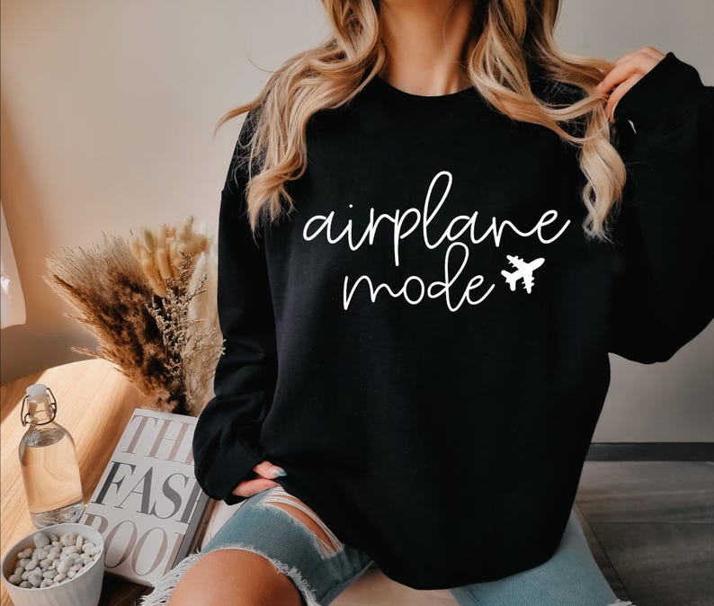 May include: Black sweatshirt with white text that reads "airplane mode" and a small airplane graphic.