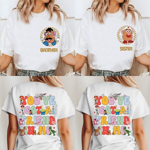 May include: White t-shirts featuring character illustrations and names: Emma, Brother, Sister, and Baby on the front. The back of the shirts display the text "YOU'VE GOT A FRIEND IN ME" with character illustrations in a colourful design.