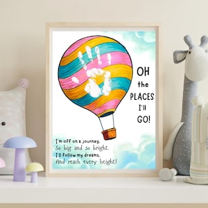 May include: A framed print featuring a colorful hot air balloon with a handprint design. The balloon is striped with pink, yellow, and blue. Text reads "OH the PLACES I'LL GO!" and a poem about journeys and dreams.