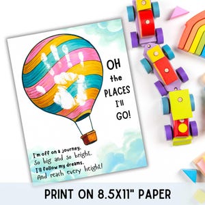 May include: A colorful print featuring a hot air balloon with a handprint design. The text "OH the PLACES I'LL GO!" is displayed, along with inspirational text. The print is on 8.5x11 inch paper. Wooden toys are scattered around the print.