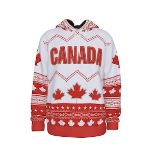 Puede incluir: Sudadera con capucha blanca con un patrón canadiense rojo y blanco. La sudadera tiene un gran texto rojo "CANADA" en la parte delantera y un diseño de hoja de arce roja.