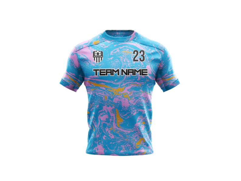 May include: A blue, pink, and gold soccer jersey with a team logo and the number 23. The text "TEAM NAME" is printed on the front of the jersey.