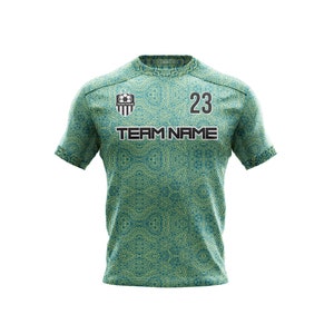 May include: Green and yellow soccer jersey with a black team logo, the text "TEAM NAME" and the number "23".