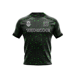 May include: Black and green soccer jersey with a geometric pattern. The jersey has a white team logo with a soccer ball and the text "TEAM NAME". The number "23" is on the front of the jersey.
