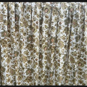 May include: White curtains with a green and brown floral pattern. The curtains have a gathered look and are made of a lightweight fabric.