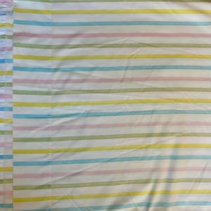 May include: A white fabric with horizontal stripes in pastel colors, including pink, blue, yellow, and green.