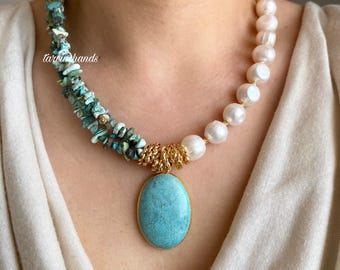 May include: A turquoise and white layered necklace with a large oval turquoise pendant. The necklace is made of small turquoise stones and large white pearls.