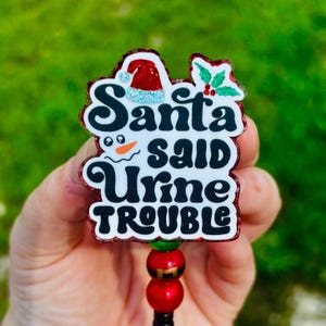 Carrete de insignias "Santa dijo que hay problemas con la orina" para Navidad