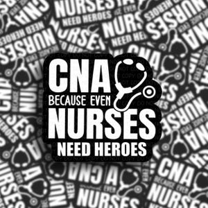May include: A black and white sticker featuring the text CNA BECAUSE EVEN NURSES NEED HEROES in a bold, sans-serif font. A graphic illustration of a stethoscope is integrated into the design, positioned next to the word CNA.