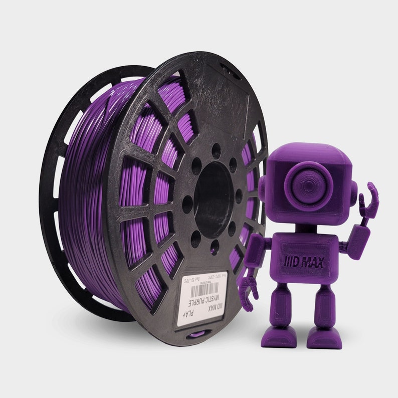 May include: A purple filament spool labeled "Mystic Purple" next to a 3D-printed purple robot. The filament is wound around a black spool. The robot has a square head and body with outstretched arms.