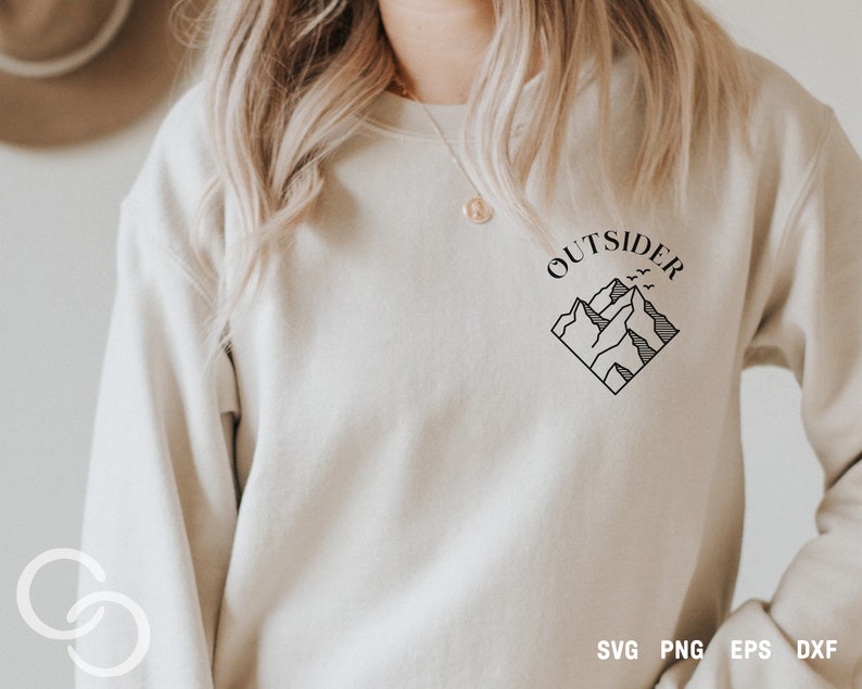 May include: A white sweatshirt with a black graphic design of mountains and the word "OUTSIDER" in a circle above the mountains.