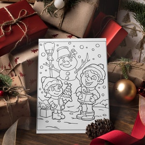 May include: A black and white coloring page featuring two children and a snowman. The children are holding a small Christmas tree and a gift box. The snowman is wearing a hat and scarf. The page is surrounded by wrapped gifts and a red ribbon.
