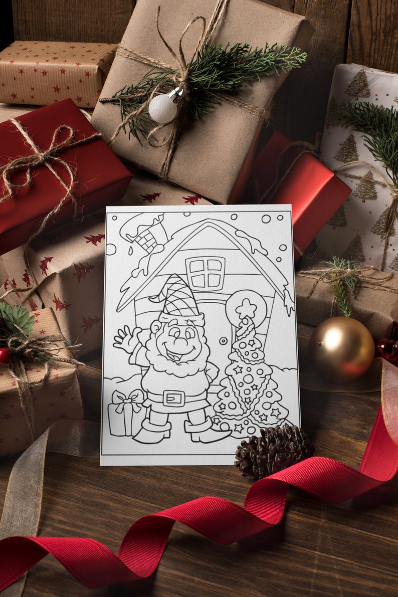 May include: A black and white coloring page featuring a gnome standing in front of a house with a Christmas tree. The gnome is holding a gift box and is smiling. The house has a chimney and a window. The Christmas tree is decorated with ornaments and stars.