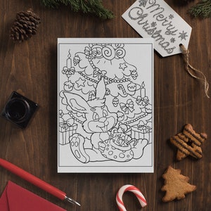 May include: A black and white coloring page featuring a bunny rabbit sitting under a decorated Christmas tree. The bunny is holding a bag of gifts. The tree is decorated with ornaments, stars, candy canes, and lights.