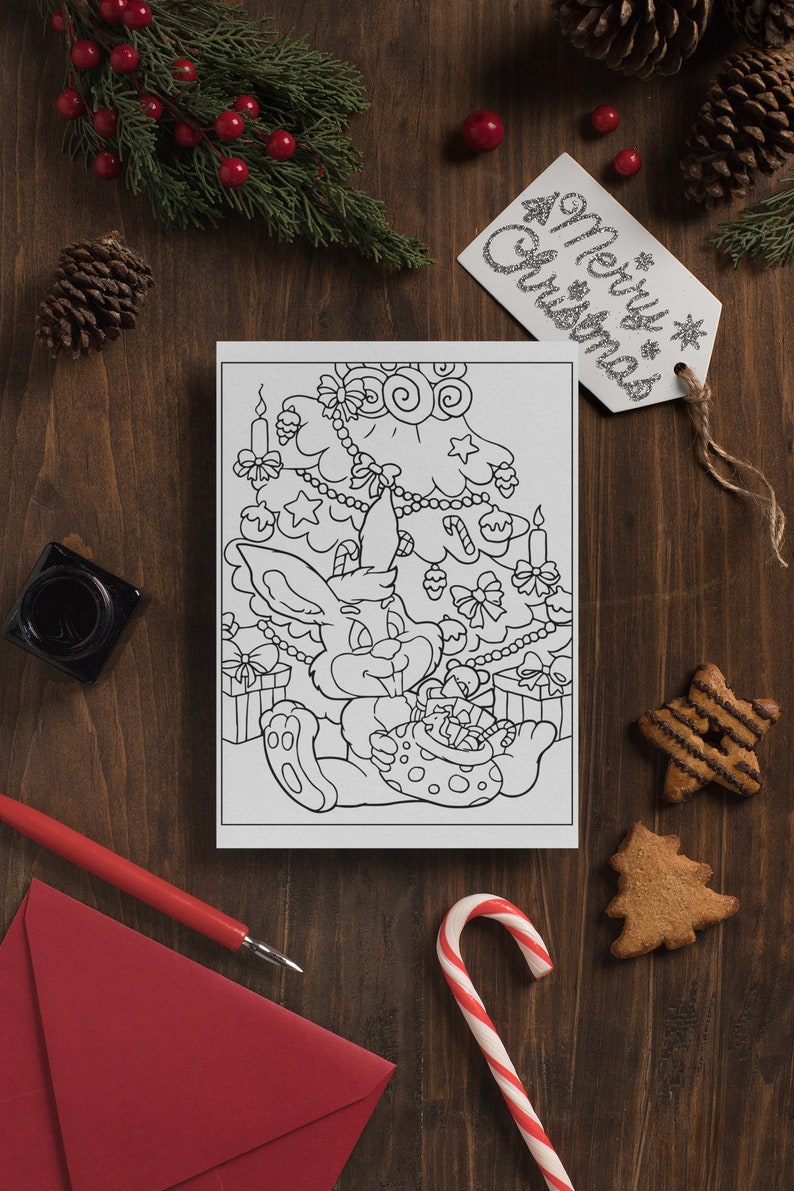 May include: A black and white coloring page featuring a bunny rabbit sitting under a decorated Christmas tree. The bunny is holding a bag of gifts. The tree is decorated with ornaments, stars, candy canes, and lights.